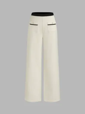 Solid color high-rise pants with contrasting trim and pearl button